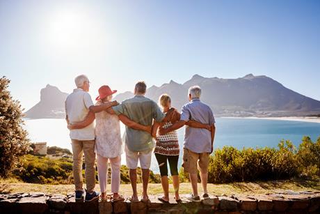 A group of friends look out over the sea during a holiday