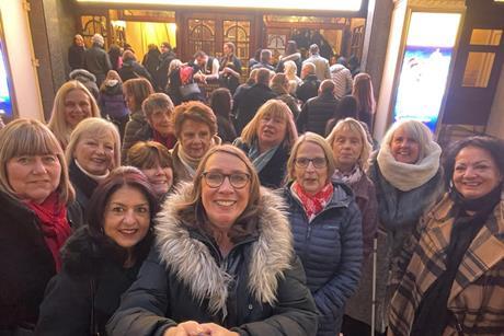 Members of Theatre Trips Essex outside the London Palladium before a show