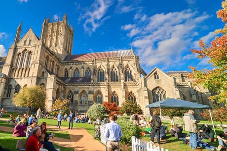 People sat on the lawns outside the Cathedral during a festival