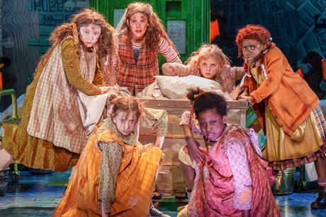 Zoe Akinyosade (Annie) and Company on stage in the Annie musical tour 2023.