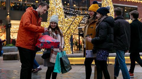 A group of shoppers looking pleased with their purchases while shopping in Lincoln