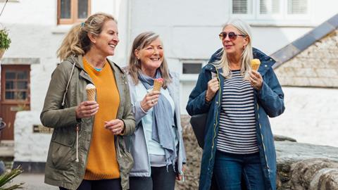 Three woman strolling along with their ice-creams