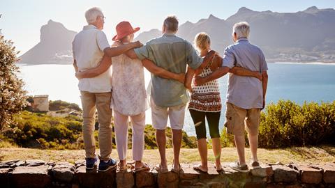 Group looking over the ocean and mountain range