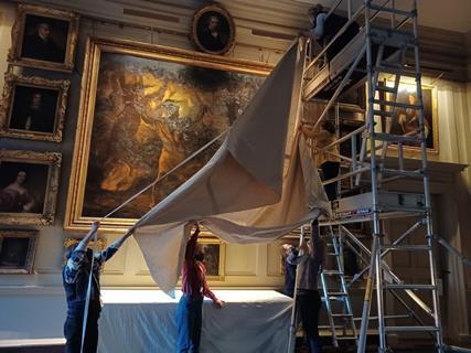 Staff at Petworth House cover the huge Macbeth painting in preparation of the filming of Napoleon