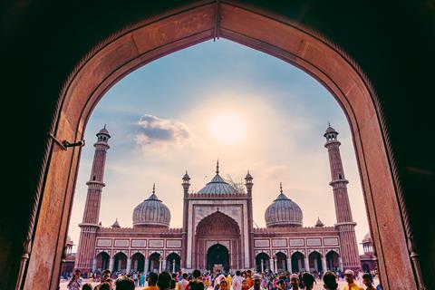 Silhouette of visitors at doorway at Jama Masjid, Old Delhi, India