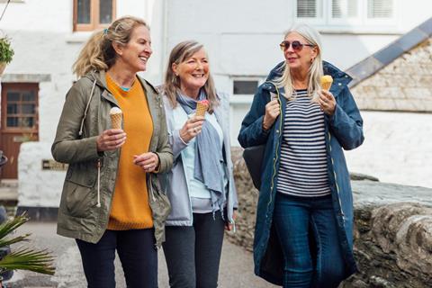 Three woman strolling along with their ice-creams