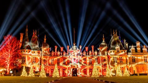 The exterior of Waddesdon Manor illuminated for Christmas