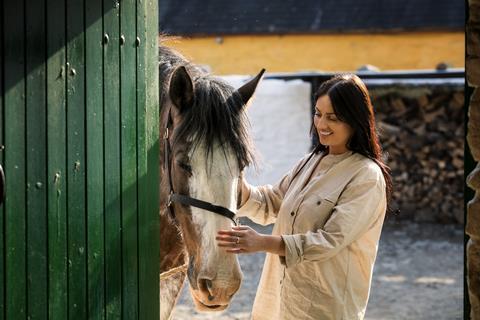 A woman petting a horse at Muckross Traditional Farms, Killarney National Park, Co Kerry_master