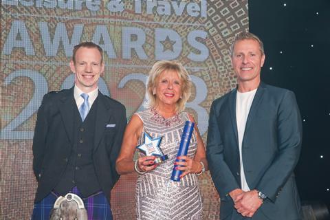 GTO Mary Gotts is presented with the GTO of the Year Award by Alan Rennie at Ambassador Cruise Line and ventriloquist Paul Zerdin