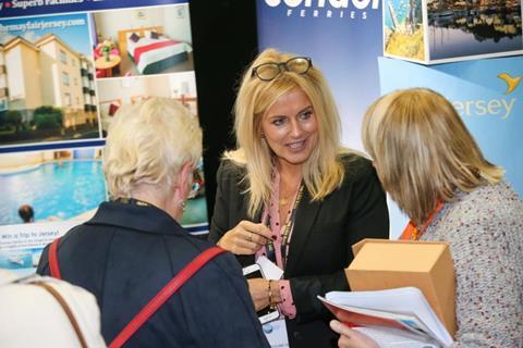 Visitors speaking with exhibitors at the Group Leisure & Travel Show