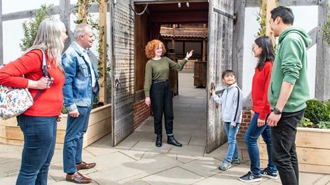 A group have a tour of Shakespeare's Globe