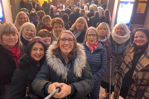 Members of Theatre Trips Essex outside the London Palladium before a show