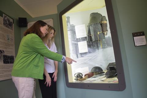Two women look at artefacts in the Secret Army exhibition at Beaulieu