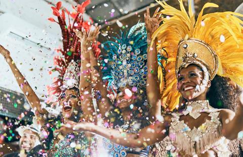 Ladies with colourful outfits as part of a carnival