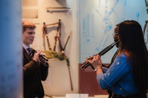 People learning to play pipes