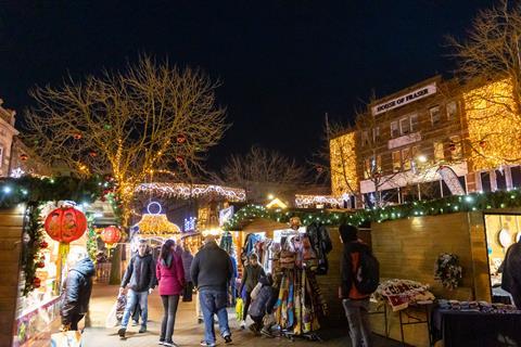 Shoppers and stalls at the twinkling Carlisle Christmas Market