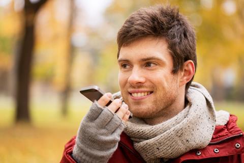 Man talking on the phone using loud speaker