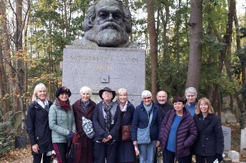 A group in front of the tomb of Karl Marx during a visit to Highgate Cemetery