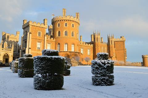 The exterior of Belvoir Castle covered in snow.