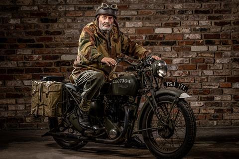 Man in military clothing on wartime motorbike