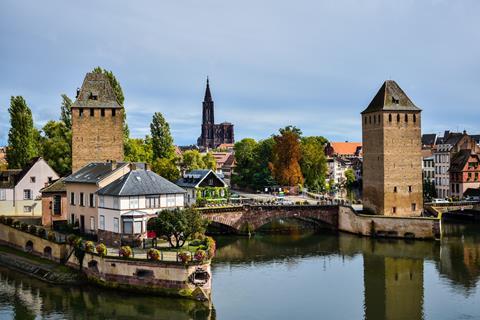 Buildings and bridge lining canal with cathedral in background