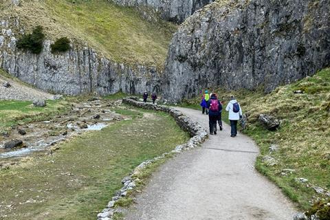 A group of walkers explore Malham Tarn in the Yorkshire Dales.