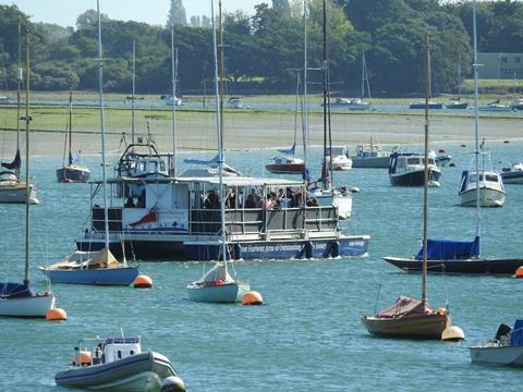 Solar Heritage weaving between boats near the jetty Itchenor