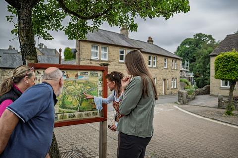 Group looking at a map of Eyam