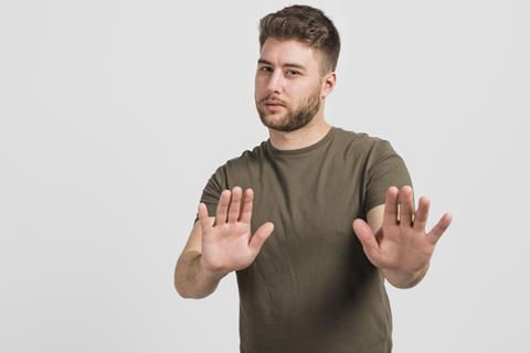 Man with hands up saying stop