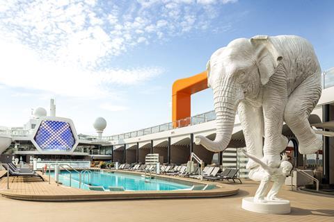 A cruise ship deck with pool and elephant scultpure