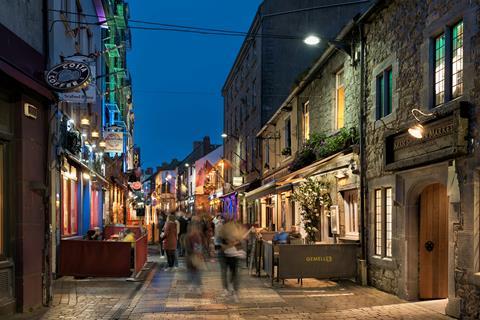 A busy street in Galway during the evening