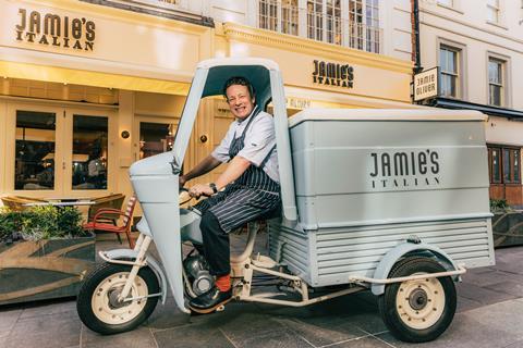 Jamie Oliver driving a scooter outside Jamie's Italian restaurant in the West End