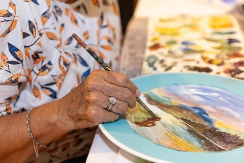 A woman painting at the Museum of Royal Worcester