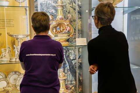 Visitors looking at a display at the Museum of Royal Worcester