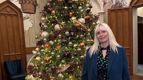 Sharon Yandell in front of a Christmas tree at Studley Castle for the Dunwood Conference
