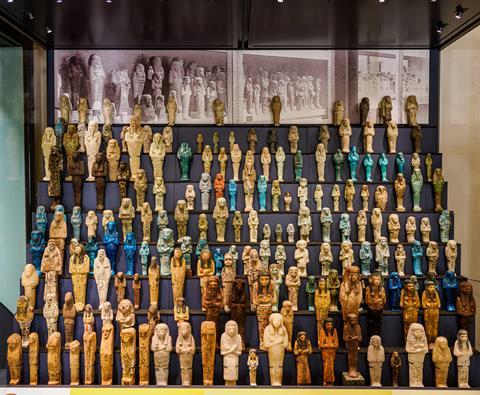 Hundreds of mummified corpses displayed in a glass cabinet from UCL's museum archive.