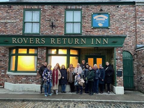 Members of the New Meridian Association outside the Rovers Return pub at the Coronation Street experience