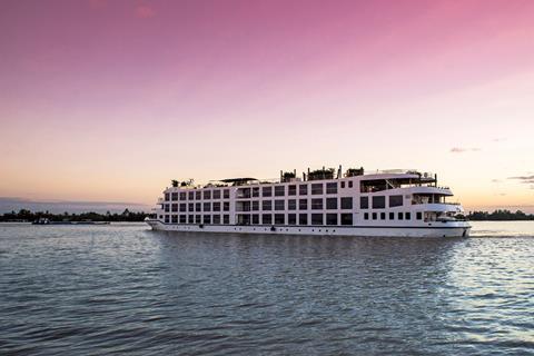 A cruise ship against a pink evening sky