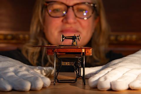 Curator Kathryn Jones prepares the miniature sewing machine for a display at Windsor Castle.