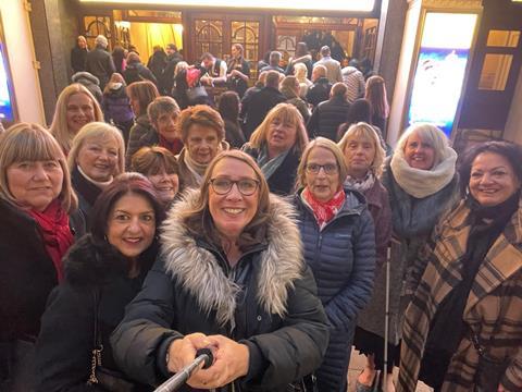 Members of Theatre Trips Essex outside the London Palladium before a show