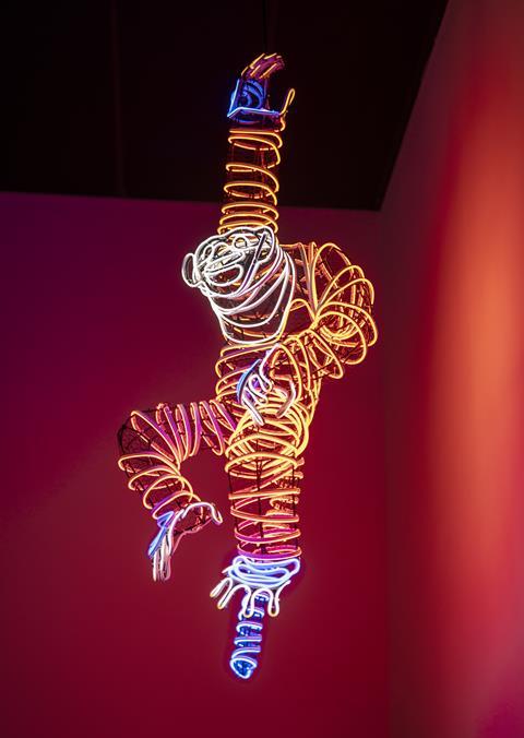 Contemporary artwork known as 'hanging monkey' showing a display of neon lights in the shape of a monkey.