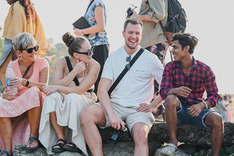 A group of friends laughing and enjoying a sunny day outdoors