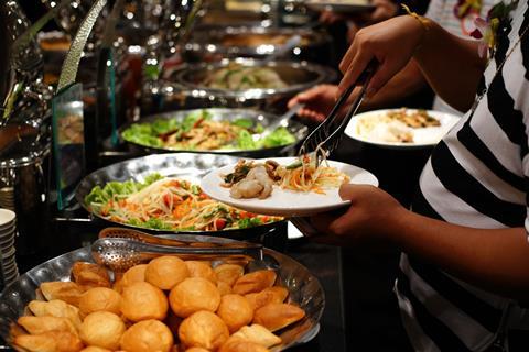 Person tucking into a buffet