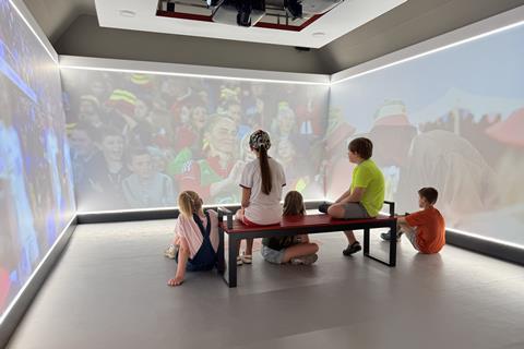 Children watching a film in a small room