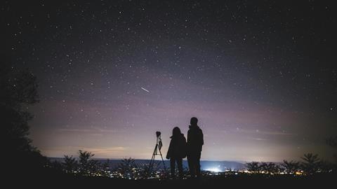 Silhouette of two people stargazing, Shenandoah National Park, Virginia USA