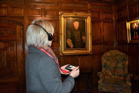 Woman using a multimedia guide at Hever Castle