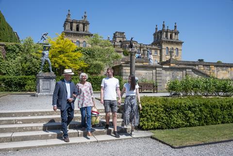 Two couples walk down the steps outside Blenheim Palace