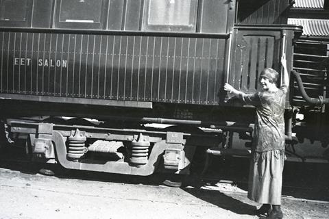 Agatha Christie posing by a train