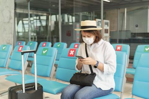 Lady at airport terminal with mask on