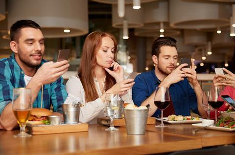 Diners absorbed by their mobile phones